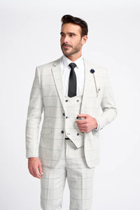 Man wearing a light gray checkered suit with a white shirt and black tie on a white background
