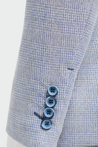 Close-up of a light blue checkered suit with three buttons on a white background