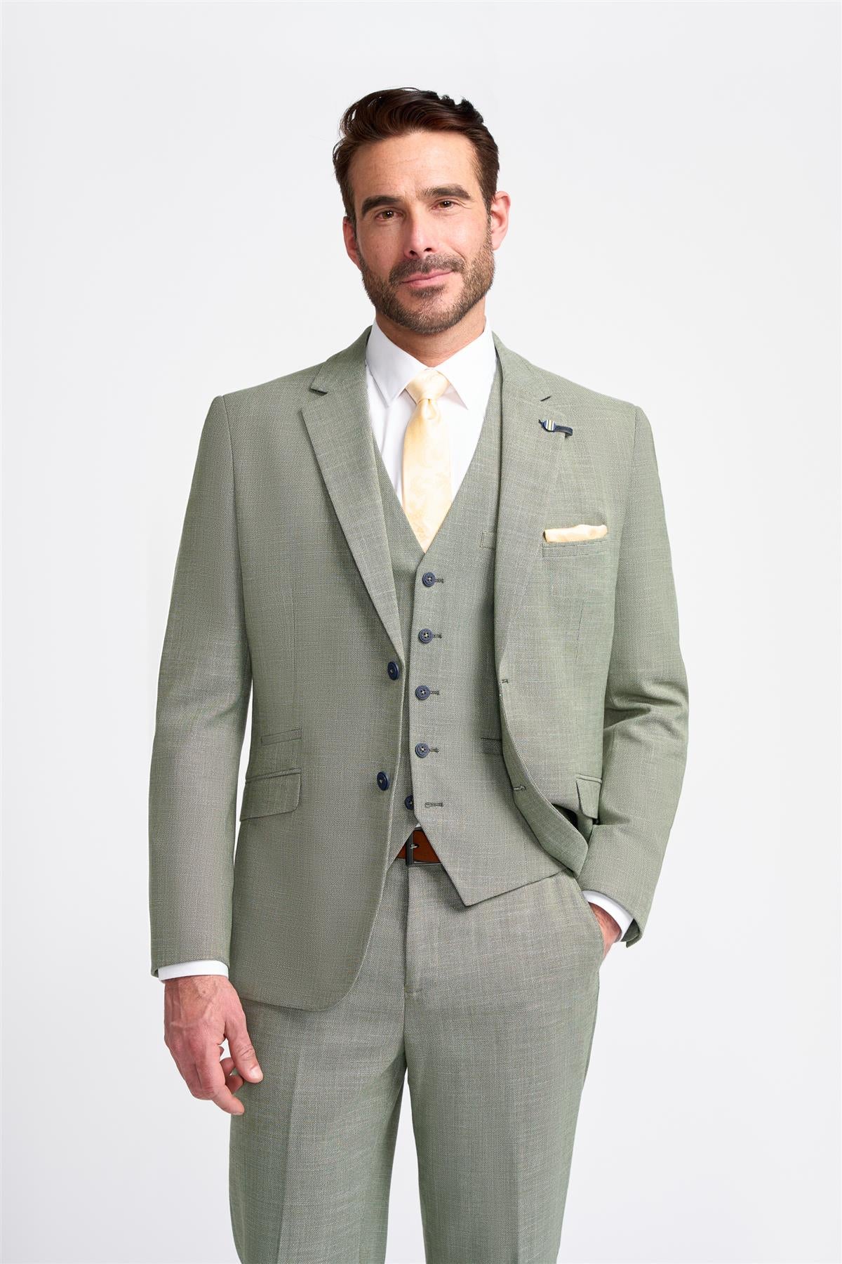 Man wearing a light gray suit with a white shirt and yellow tie on a white background